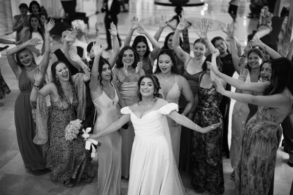 Bride celebrating with female wedding guests arms raised at luxury destination wedding in Antalya Turkey by Ramarossi