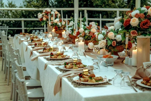 Luxury wedding table with plated starters floral centrepieces and candlelight at destination wedding in Antalya Turkey by Ramarossi
