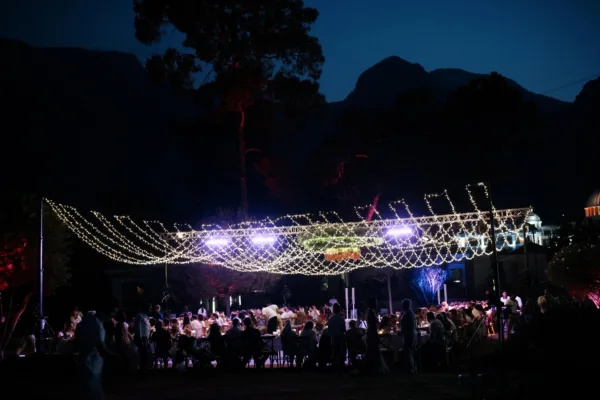 Outdoor wedding reception under fairy light canopy with Taurus Mountains at night in Antalya Turkey planned by Ramarossi