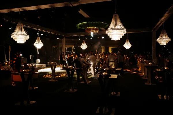 Henna night celebration with crystal chandeliers cocktail tables and guests dancing at outdoor venue in Antalya Turkey by Ramarossi