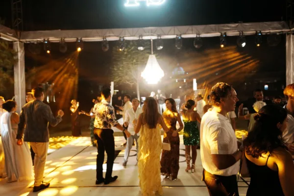 Guests dancing on outdoor dance floor with professional lighting and chandelier at henna night celebration in Antalya Turkey by Ramarossi