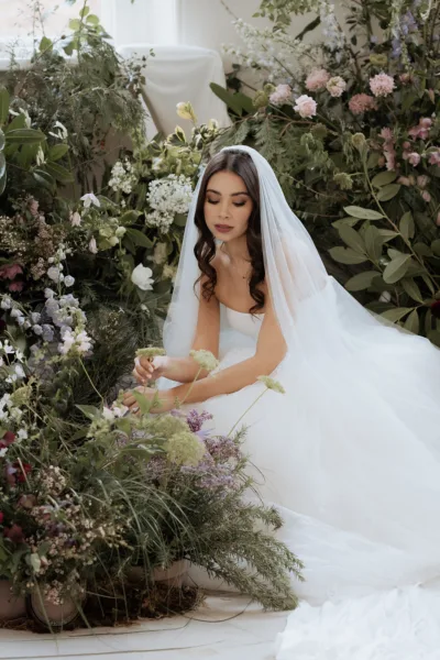 Editorial bridal portrait surrounded by florals at Iscoyd Park in Shropshire, captured in a soft, romantic style by Cleo Stella Photography.