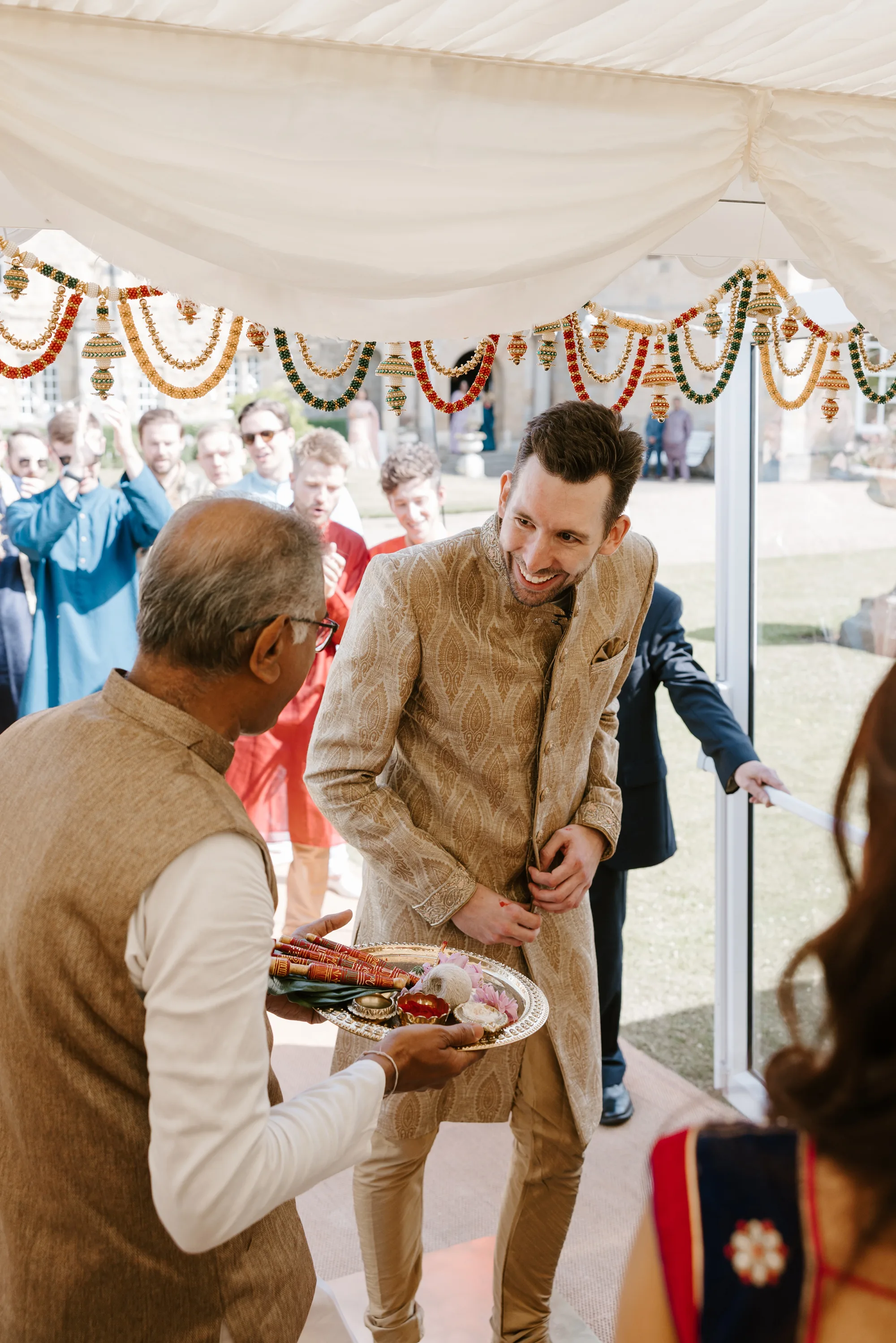 Fusion HIndu Wedding Newburgh Priory 13 - Hema & Will's Fusion Wedding & Hindu Ceremony at Newburgh Priory Groom arriving at his Hindu wedding ceremony being greeted by family members offering him treats.