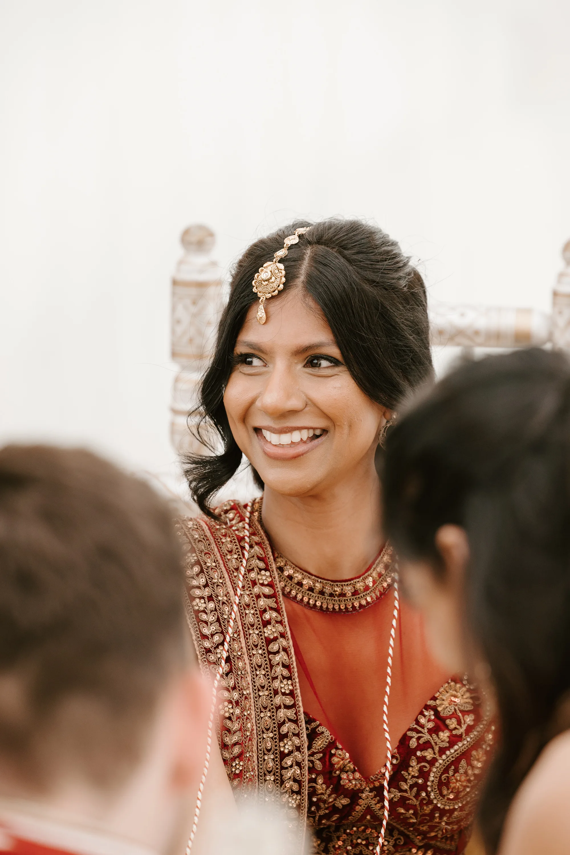 Fusion HIndu Wedding Newburgh Priory 21 1 - Hema & Will's Fusion Wedding & Hindu Ceremony at Newburgh Priory Hindu bride wearing a gold maang tikka with a gold and red lehenga.