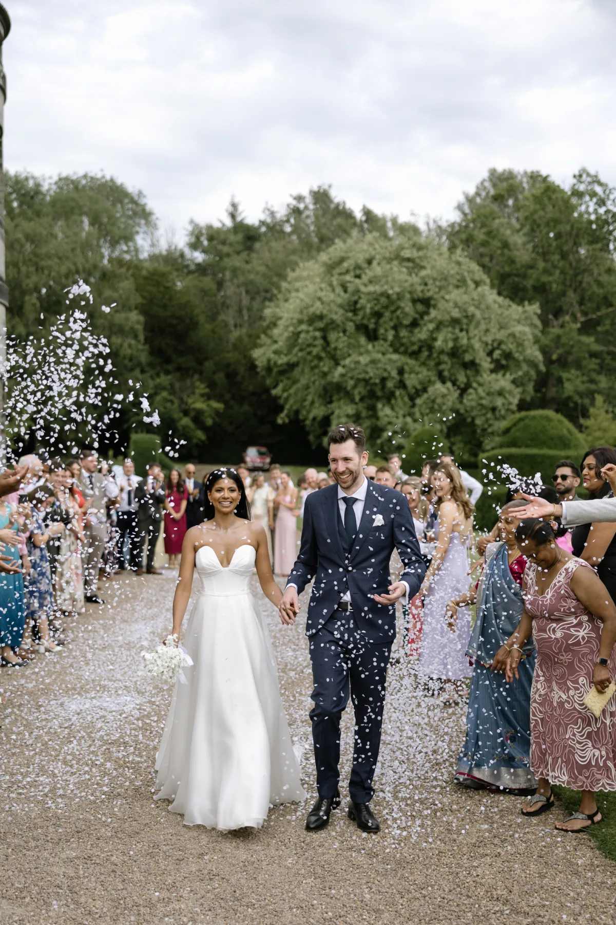 Fusion HIndu Wedding Newburgh Priory 89 - Hema & Will's Fusion Wedding & Hindu Ceremony at Newburgh Priory Bride and groom showered in white confetti petals at Newburgh Priory. The bride wears Suzanne Neville.