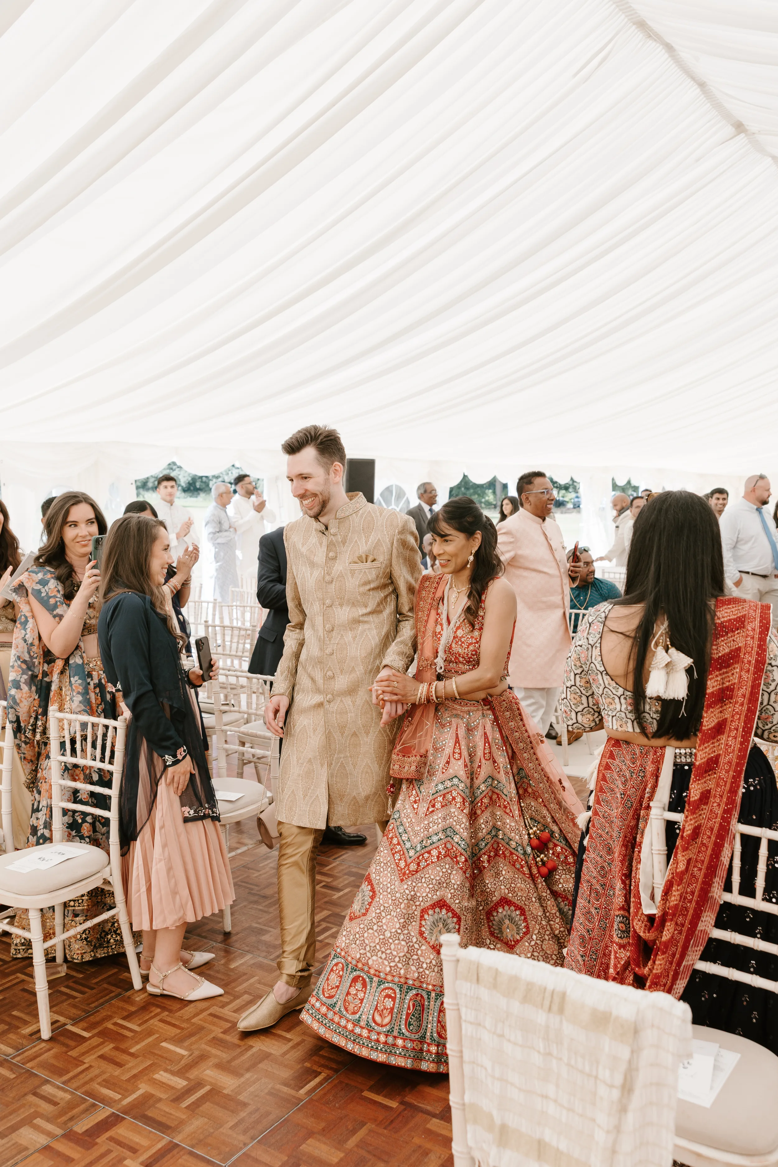 HEMA WILL 14 - Hema & Will's Fusion Wedding & Hindu Ceremony at Newburgh Priory Groom arriving at his Hindu wedding ceremony wearing traditional Hindu wedding gold attird. He is holding the hand of the bridesmaid.