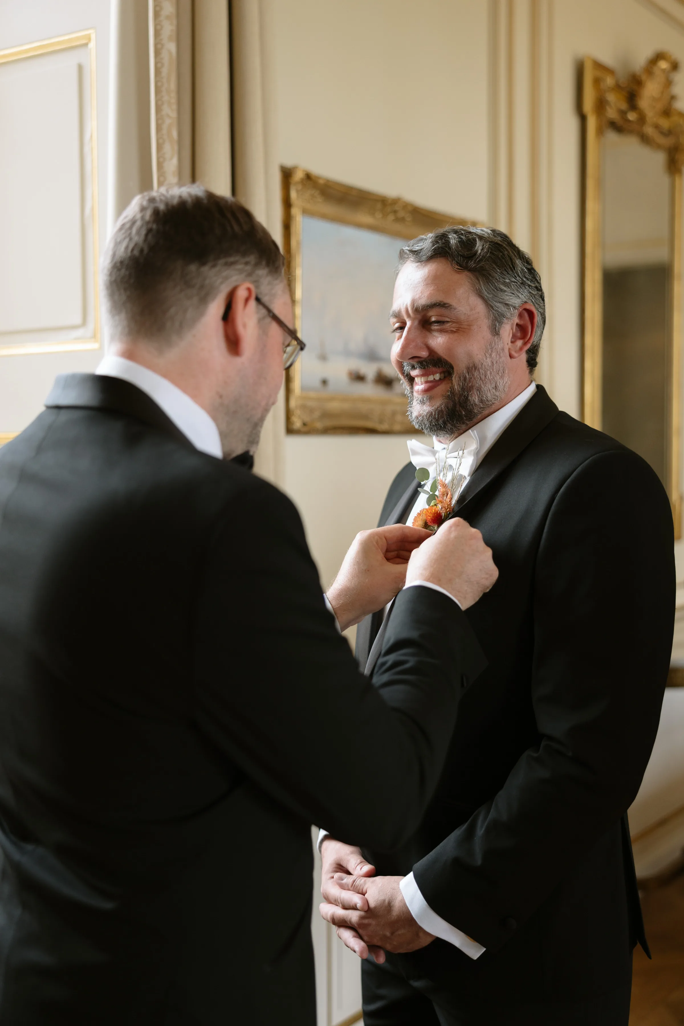 Indie Bride London Chateau Cazenac wedding France 10 - Laura & Ben's Romantic & Intimate Wedding Day Gathering at Chateau Cazenac in The Dordogne Groom in black tie attire being assisted with his button hole by his best man.