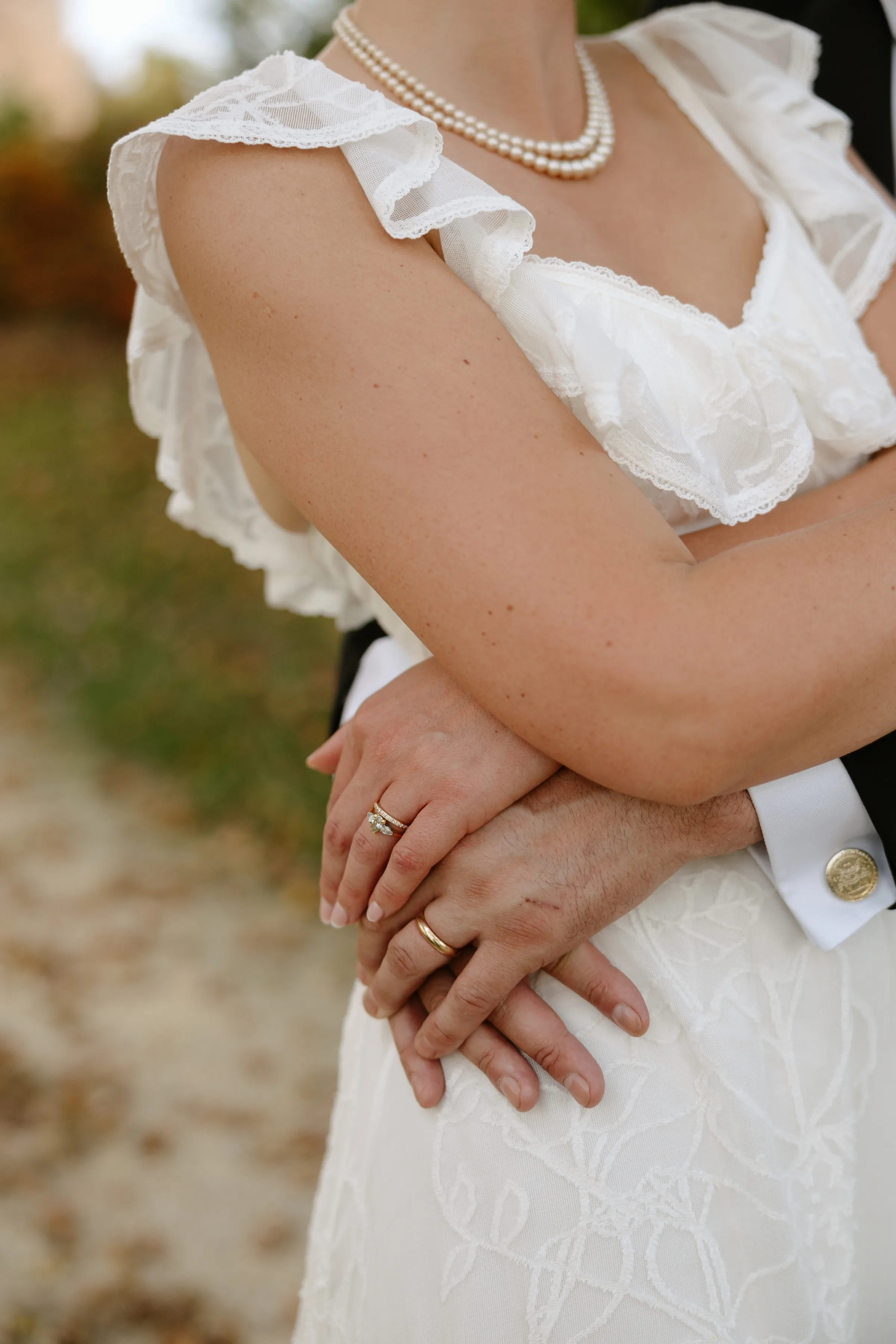 Indie Bride London Chateau Cazenac wedding France 160 - Laura & Ben's Romantic & Intimate Wedding Day Gathering at Chateau Cazenac in The Dordogne Close up shot of bride and and groom's hands with a focus on rings.