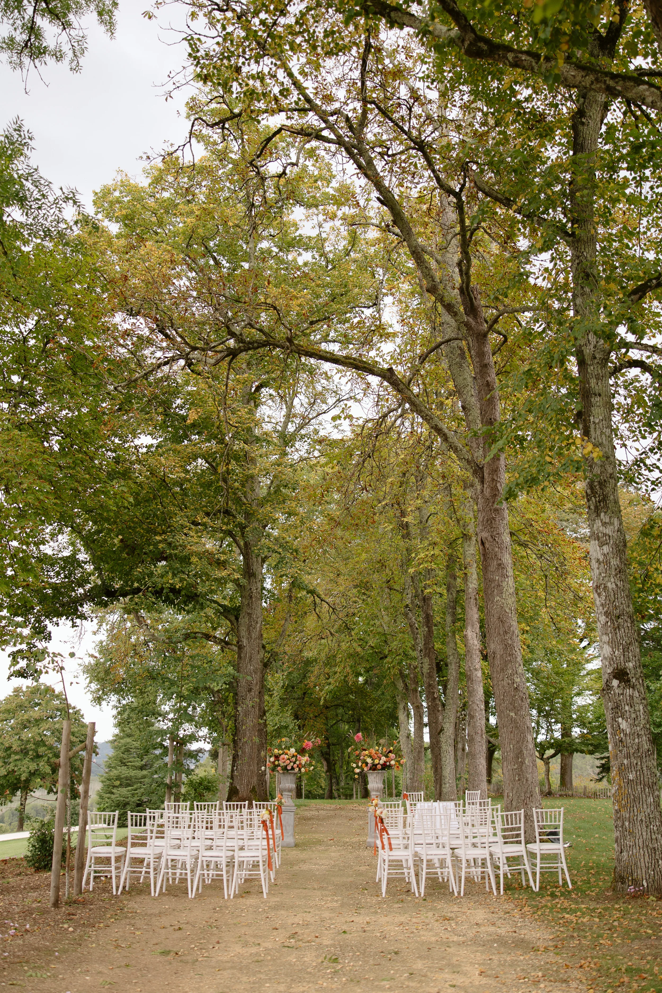 Indie Bride London Chateau Cazenac wedding France 18 - Laura & Ben's Romantic & Intimate Wedding Day Gathering at Chateau Cazenac in The Dordogne Outdoor wedding ceremony seating line by tall trees at Chateau Cazenac, a wedding venue in the Dordogne in France.