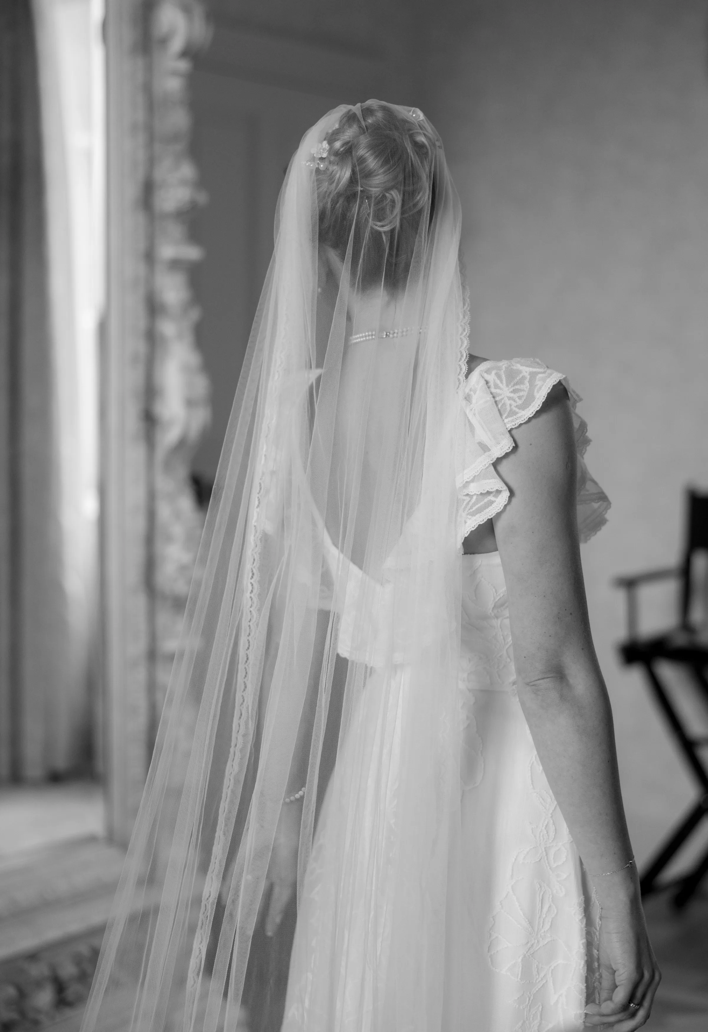 Indie Bride London Chateau Cazenac wedding France 30 - Laura & Ben's Romantic & Intimate Wedding Day Gathering at Chateau Cazenac in The Dordogne Bide with a high bun covered in a single tier ver and ruffle sleeve wedding dres.