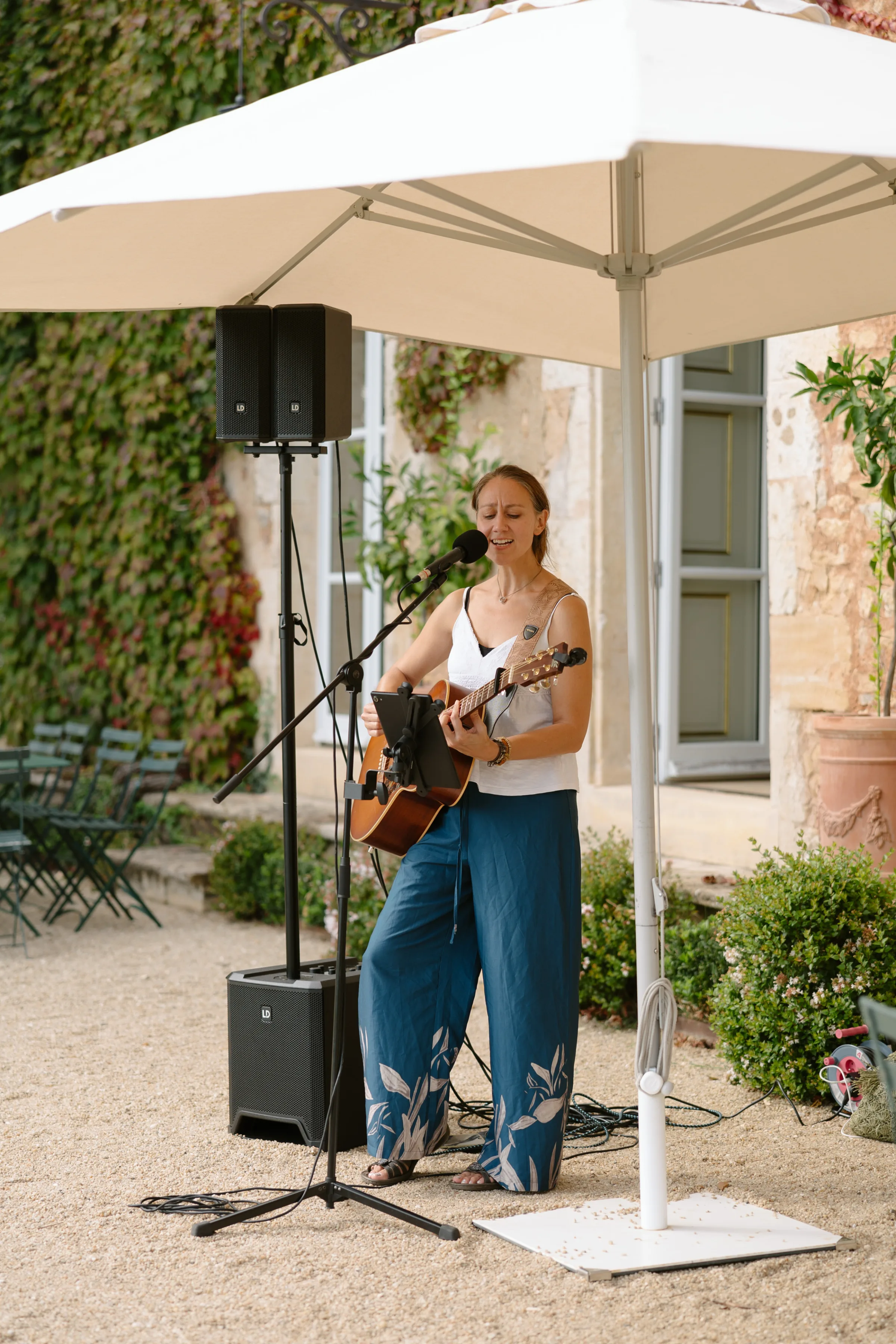 Indie Bride London Chateau Cazenac wedding France 77 1 - Laura & Ben's Romantic & Intimate Wedding Day Gathering at Chateau Cazenac in The Dordogne Guitarist performing acoustic music for wedding guests.