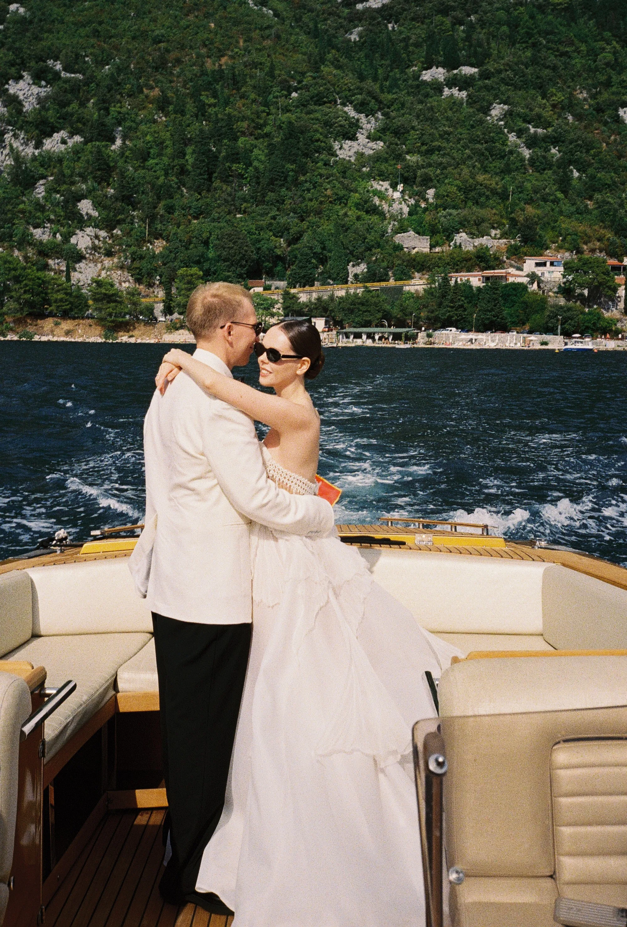 Montenegro Wedding 1 1 - A Romantic & Intimate Montenegro Wedding at Villa Shah, Inspired by 'La Vita Nobile' Portraits of a bride and groom on a speedboat in Montenegro. Groom wears a white tuxedo jacket and black bow tie. The bride wears a Rara Couture gown with compressed silk corset detail.