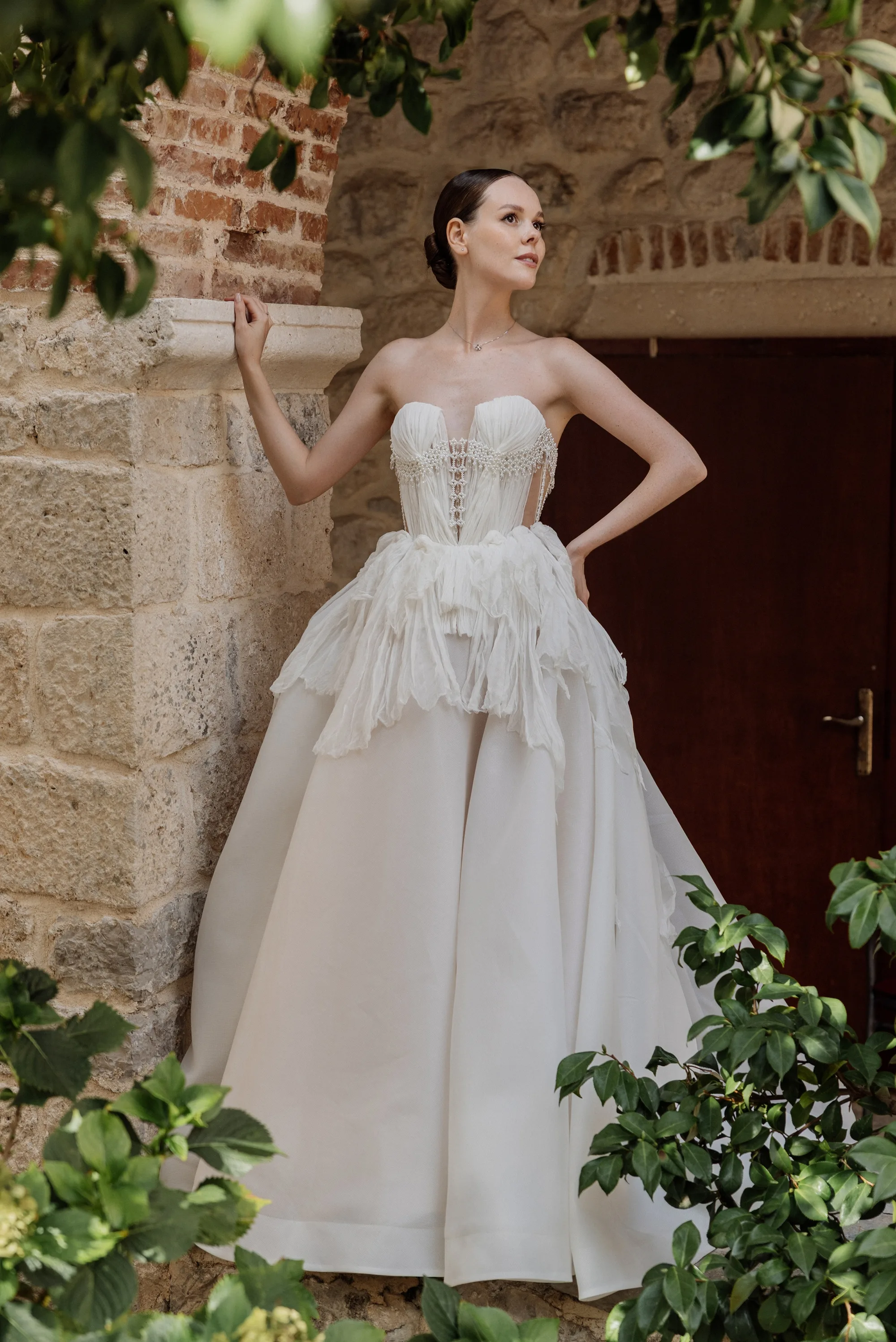 Montenegro Wedding 54 - A Romantic & Intimate Montenegro Wedding at Villa Shah, Inspired by 'La Vita Nobile' Bride standing in the garden wearing a Rara Couture bridal gown with a corset created from compressed silk.