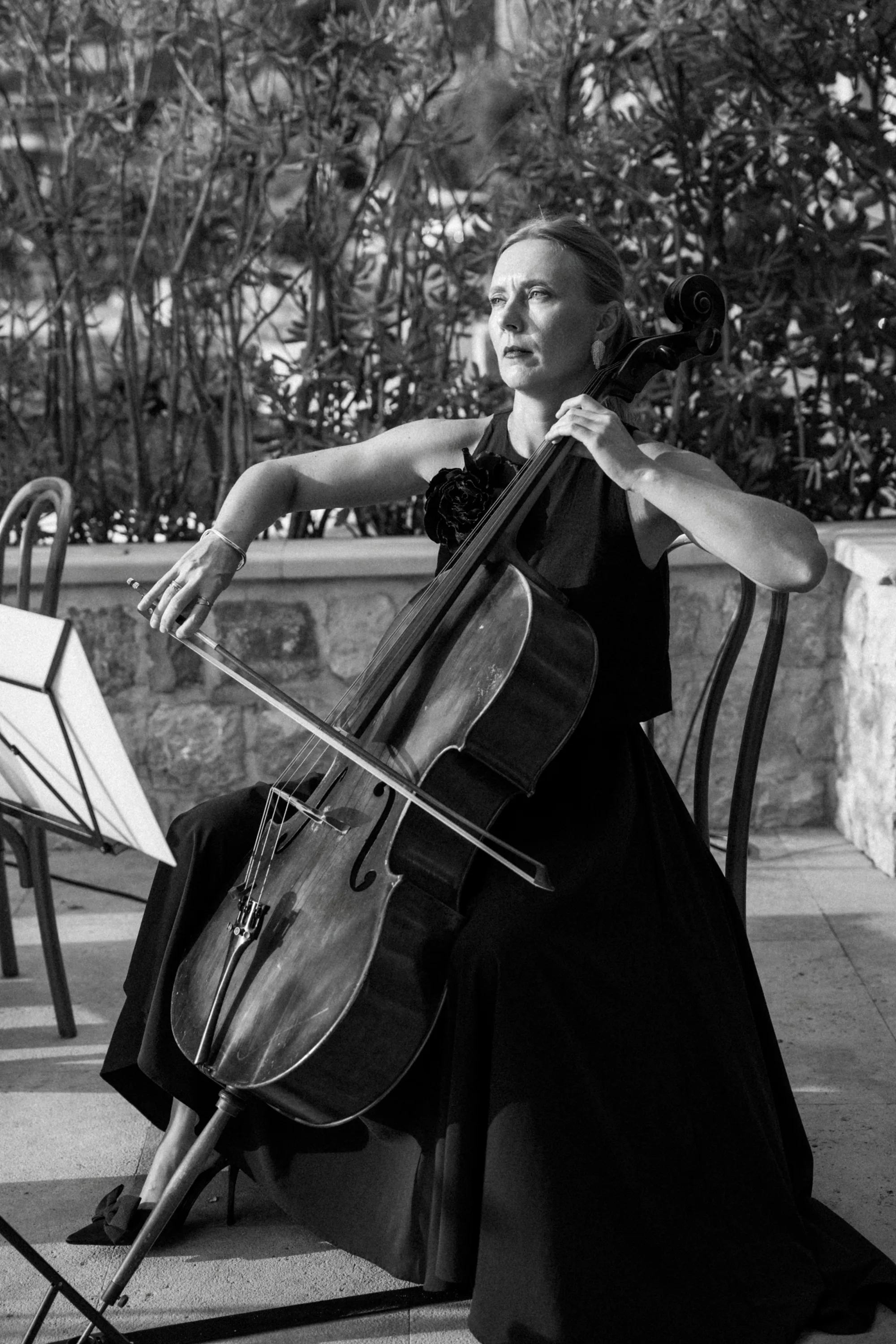 Montenegro Wedding 76 - A Romantic & Intimate Montenegro Wedding at Villa Shah, Inspired by 'La Vita Nobile' Cello player seated and playing the cello on a wedding day.