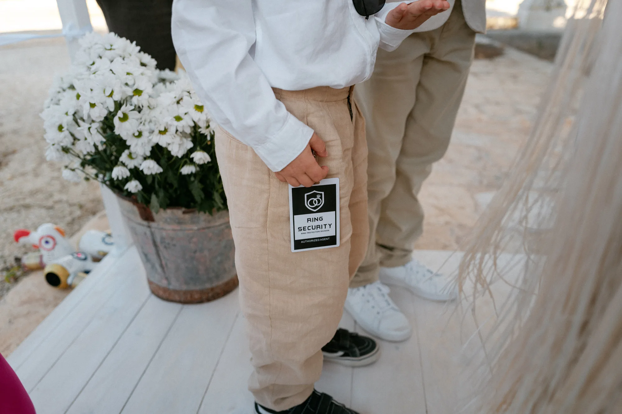 Multiple Day Destination Wedding in Masseria Potenti Puglia Italy 85 - Yael Wore Chana Marelus & A Handmade Beaded Veil for her Relaxed Italian Masseria Wedding Page boy holding a ring security tag.