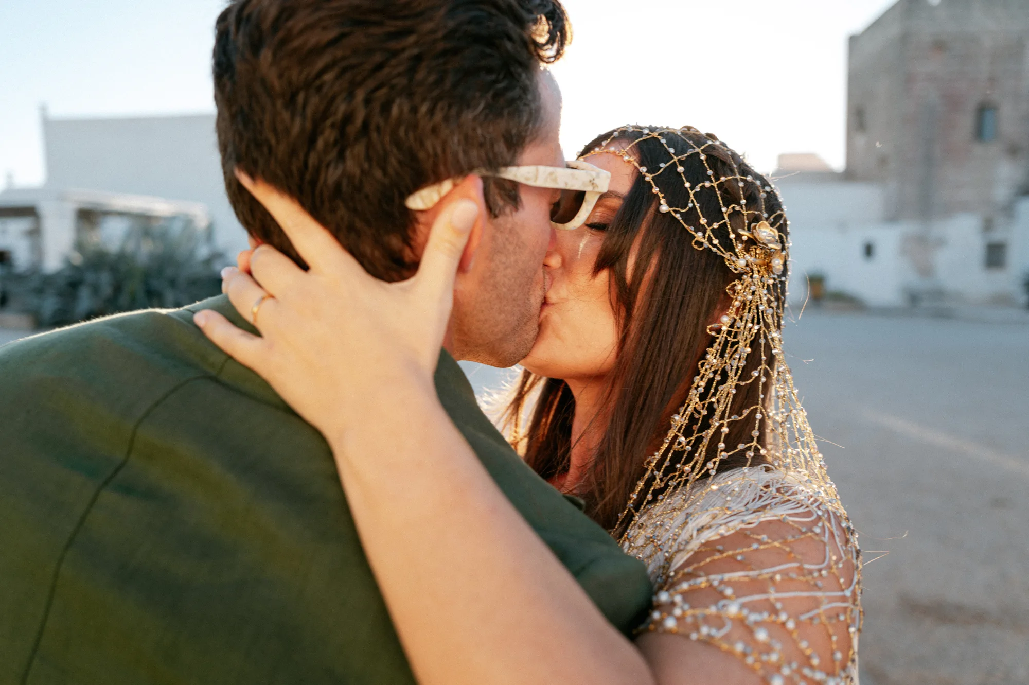Multiple Day Destination Wedding in Masseria Potenti Puglia Italy 87 - Yael Wore Chana Marelus & A Handmade Beaded Veil for her Relaxed Italian Masseria Wedding Bride in a beaded veil clutching her groom's face and kissing him.