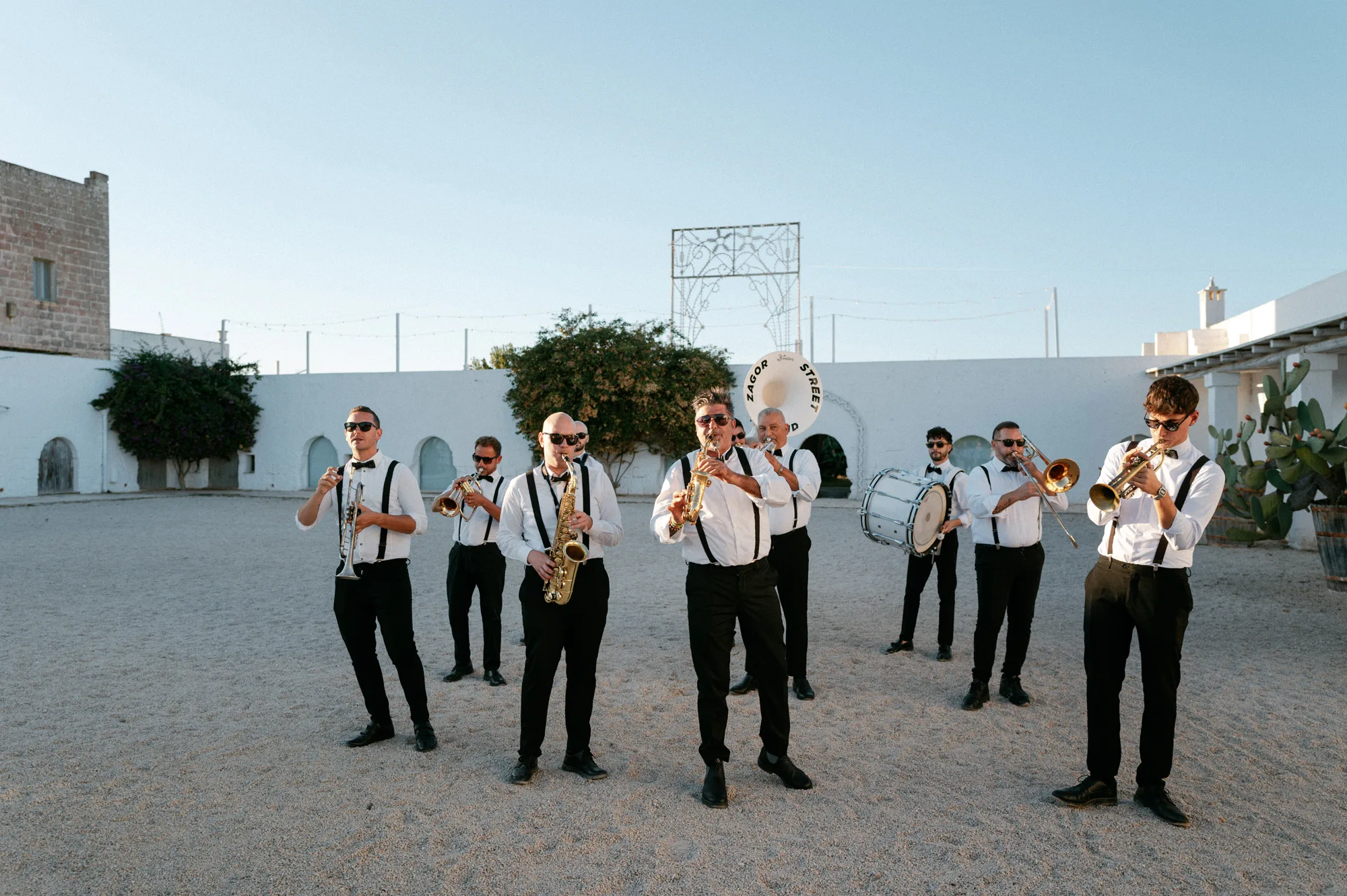 Multiple Day Destination Wedding in Masseria Potenti Puglia Italy 90 - Yael Wore Chana Marelus & A Handmade Beaded Veil for her Relaxed Italian Masseria Wedding Roaming brass band playing at a wedding in s at Masseria Potenti wedding venue in Puglia Italy.