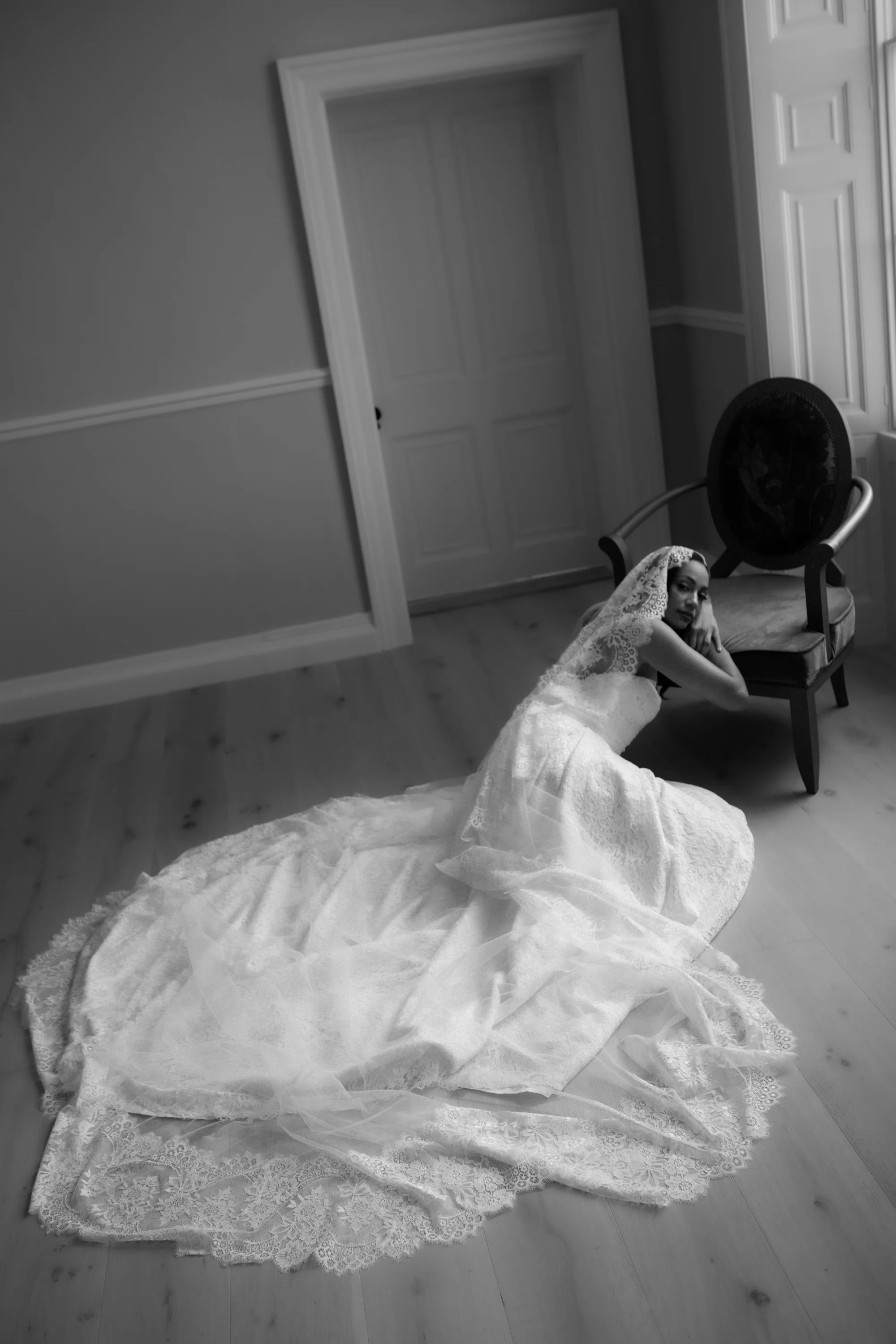 Rebecca Anne Designs embroidered wedding veils 36 - Introducing the New Embroidered Wedding Veil & Bridal Accessories Collection by Rebecca Anne Designs Black model bride seated but leaning forward with her head rested in the palm of her hand. She wears a beautiful lace mantilla lace edged veil by Rebecca Anne Designs.