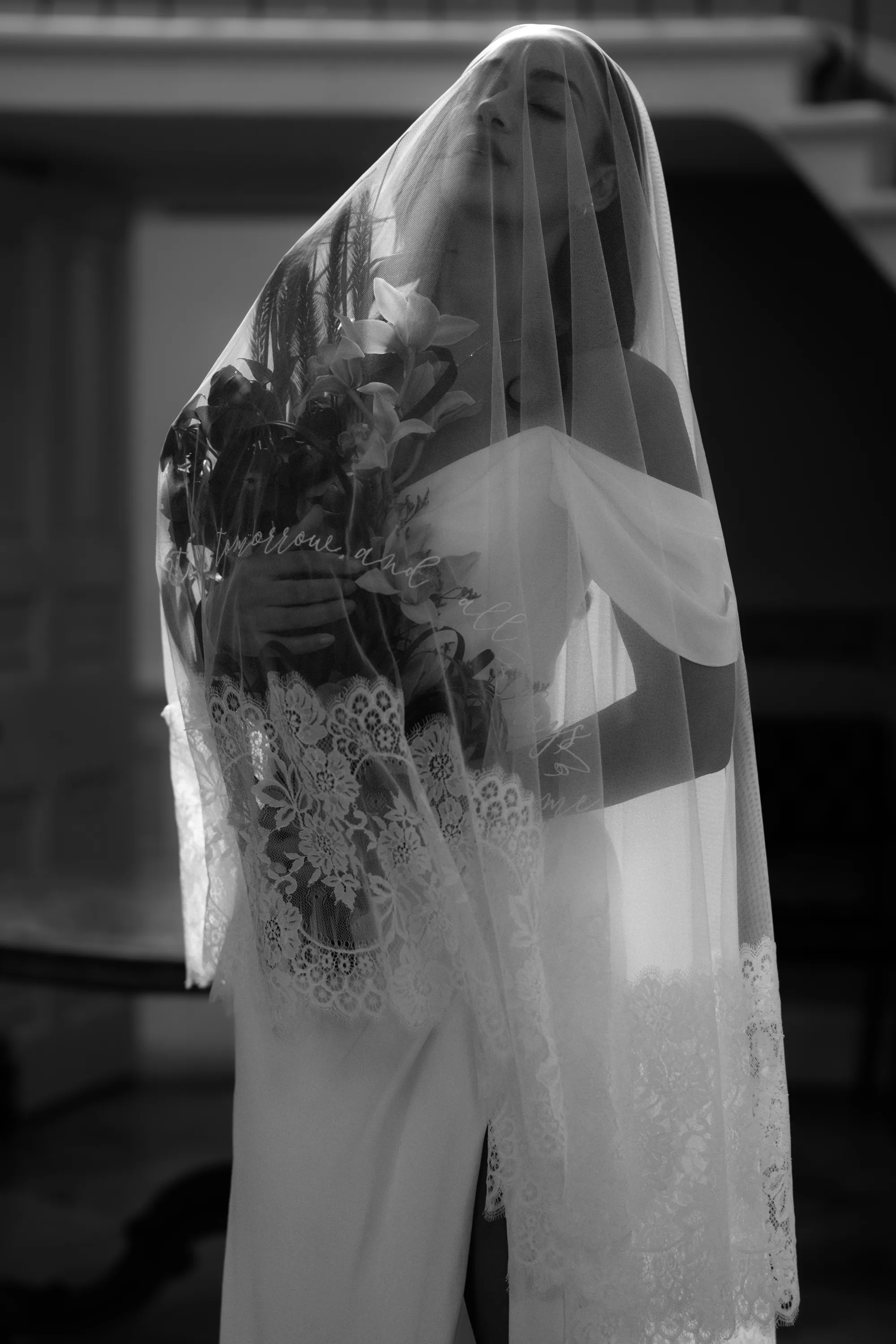 Rebecca Anne Designs embroidered wedding veils 44 - Introducing the New Embroidered Wedding Veil & Bridal Accessories Collection by Rebecca Anne Designs Sensuous black and white shot of a model bride clutching her bouquet close to her chest beneath an embroidered wedding veil by Rebecca Anne Designs.