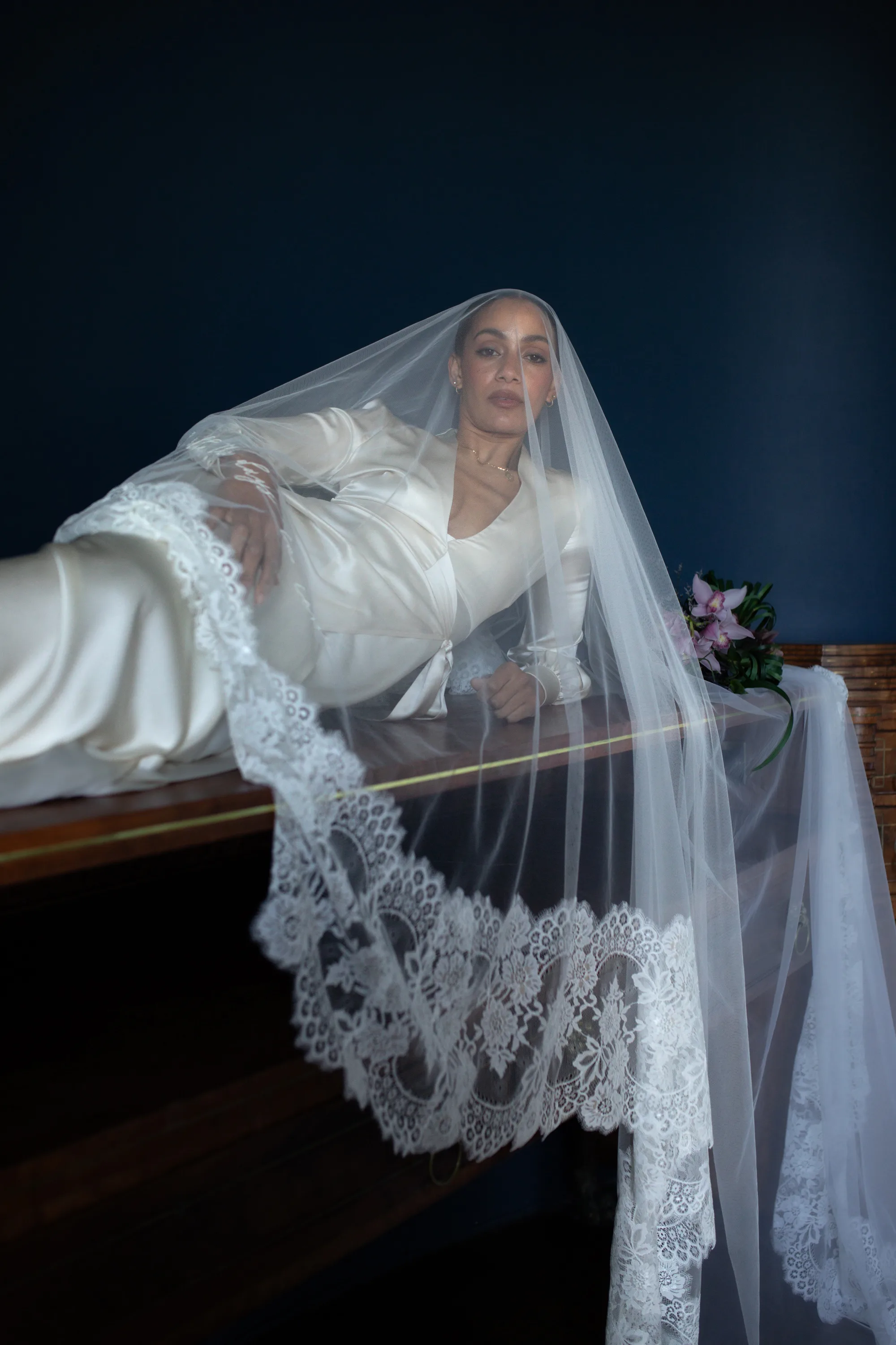 Rebecca Anne Designs embroidered wedding veils 78 - Introducing the New Embroidered Wedding Veil & Bridal Accessories Collection by Rebecca Anne Designs Model lid on her side propping herself up on her elbow to show off the elgance of her embroidered veil by Rebecca Anne Designs.