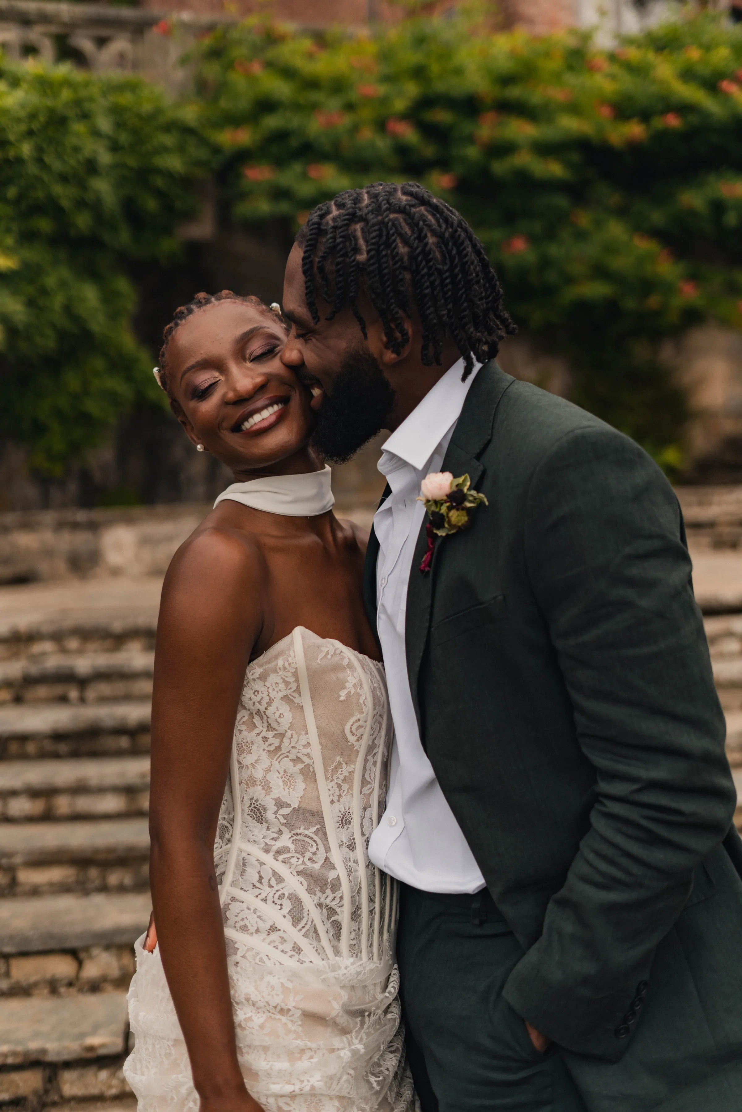 SS Port Lympne Safari Park New Orleans Wedding Editorial The Chamberlins Film Medium Format Photography London Surrey 577 - Wedding Inspiration That Celebrates The Joy, Diversity & Vibrancy of New Orleans Black bride and groom smiling as the groom leans in to the bride's face in. romantic gesture. the bride wears a dress featuring a lace corset.