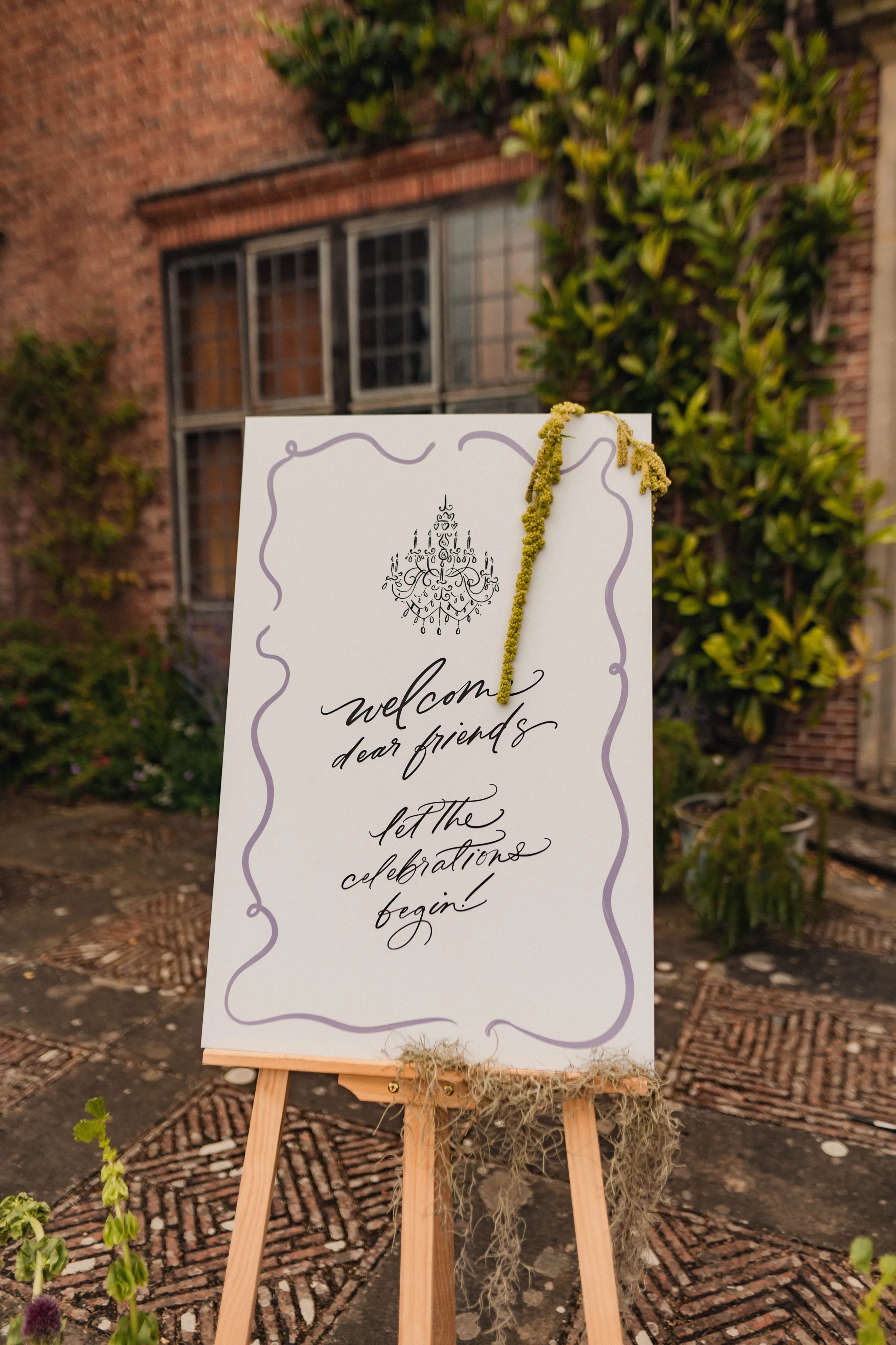 SS Port Lympne Safari Park New Orleans Wedding Editorial The Chamberlins Film Medium Format Photography London Surrey 618 - Wedding Inspiration That Celebrates The Joy, Diversity & Vibrancy of New Orleans Welcome sign standing on an easel created for a New Orleans and Mardi Gras inspired wedding venue.