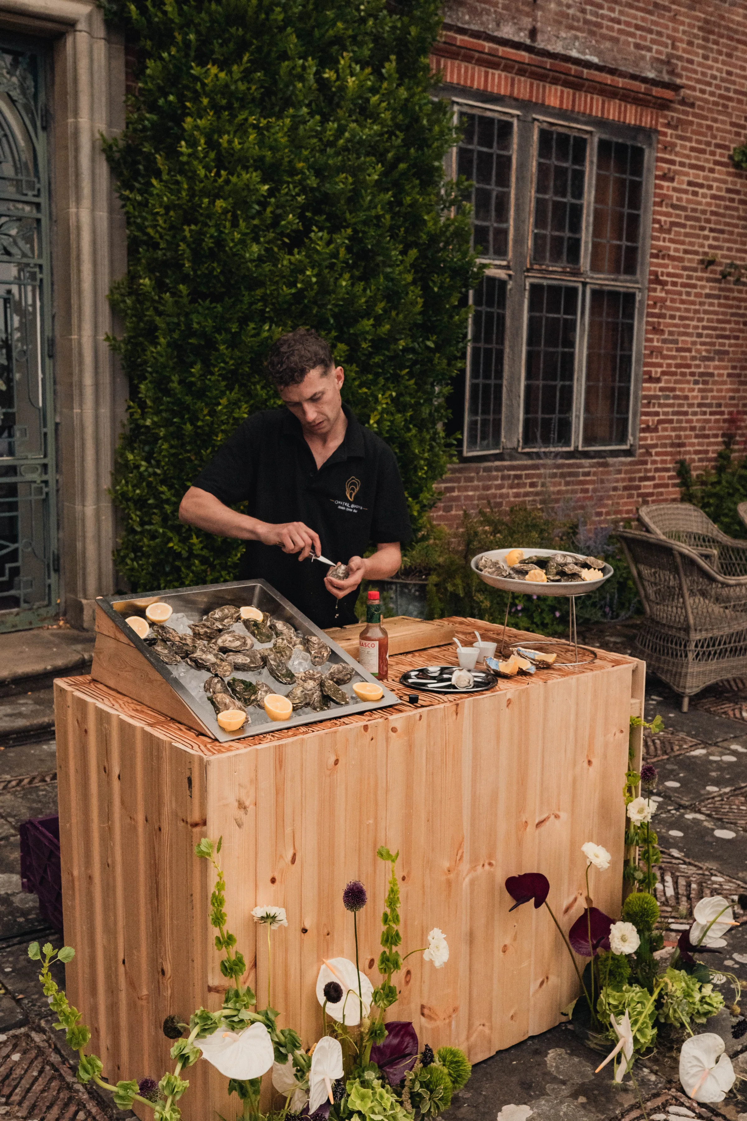 SS Port Lympne Safari Park New Orleans Wedding Editorial The Chamberlins Film Medium Format Photography London Surrey 669 - Wedding Inspiration That Celebrates The Joy, Diversity & Vibrancy of New Orleans Live oysters being served at an oyster bar.