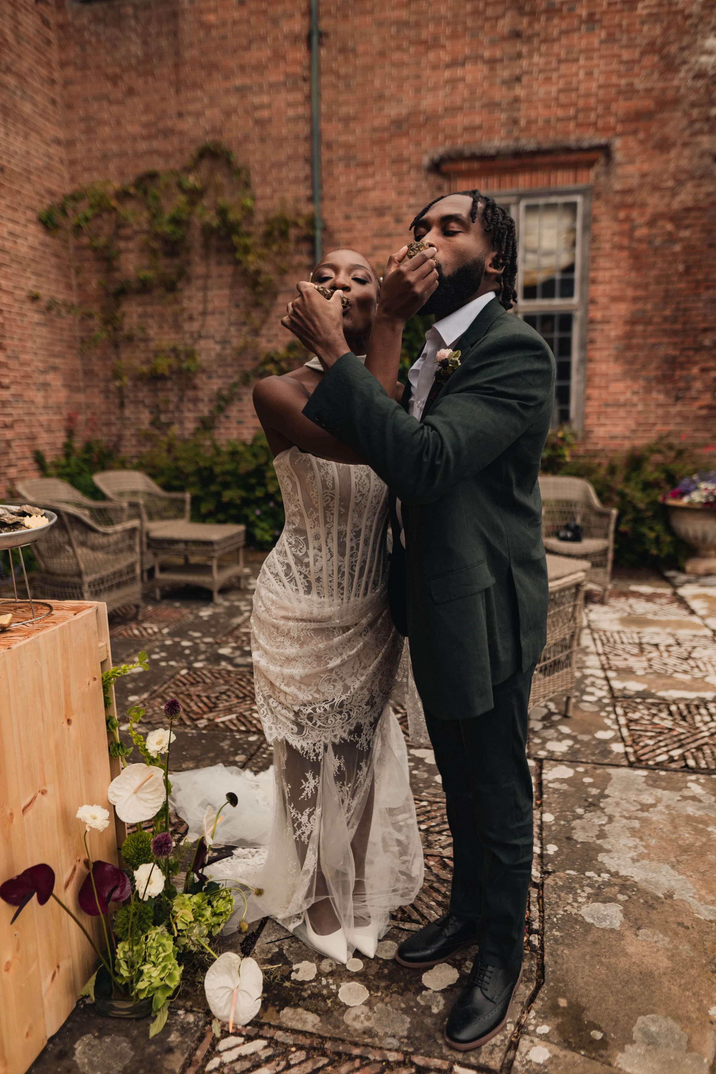 SS Port Lympne Safari Park New Orleans Wedding Editorial The Chamberlins Film Medium Format Photography London Surrey 672 - Wedding Inspiration That Celebrates The Joy, Diversity & Vibrancy of New Orleans Black bride and groom enjoying oysters.