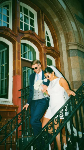 Luxury UK wedding couple walking through countryside venue at golden hour, natural candid wedding content by DuoVision