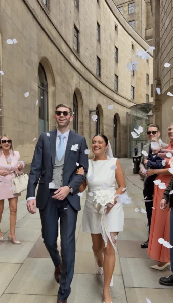 Luxury UK wedding couple walking through countryside venue at golden hour, natural candid wedding content by DuoVision