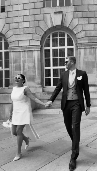 Luxury UK wedding couple walking through countryside venue at golden hour, natural candid wedding content by DuoVision