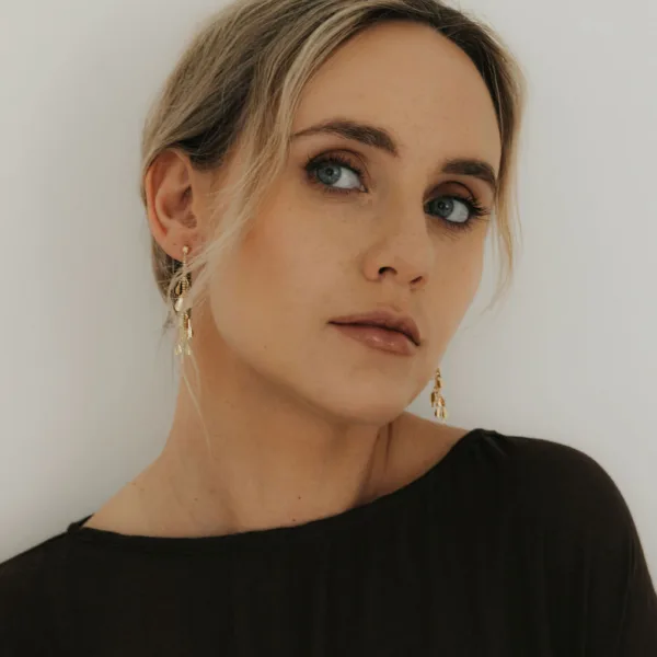 Woman wearing solid 9ct yellow gold drop earrings by THERESHEIS.jewels, Edinburgh