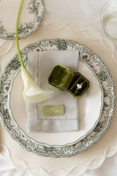 Wedding place setting with a patterned plate, calla lily and place card, tablescape styling by Zahra Studio Events