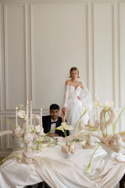Newlyweds at a candlelit white reception lounge, a luxury wedding design by Zahra Studio Events