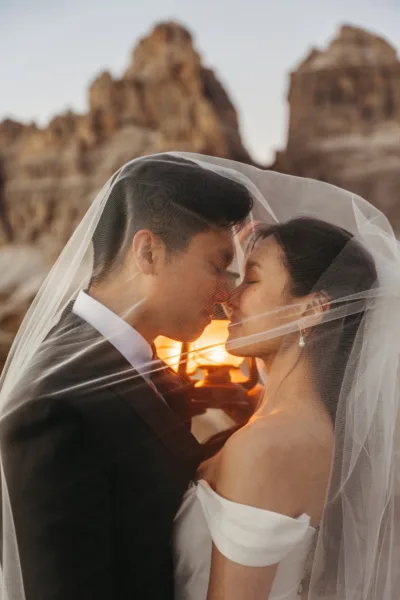 Bride and groom at blue hour with lanterns behind them and Tre Cime