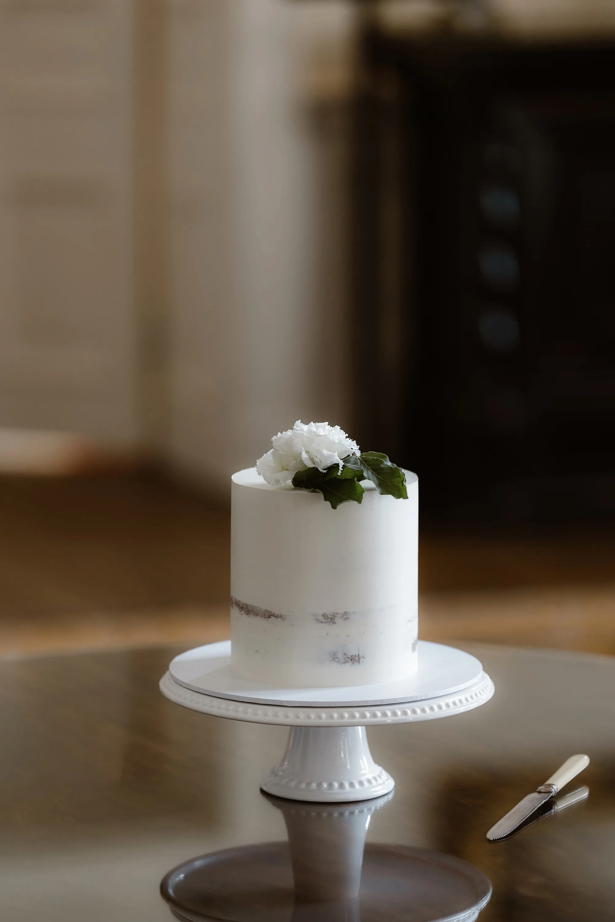 Capesthorne Hall Summer Wedding Jessica Sharpe Wedding Planner Jono Symonds Love My Dress.104 - Sophie & Dimitri's Beautiful, Relaxed & Elegant Wedding Weekend at Capesthorne Hall in Cheshire Single tier wedding cake on an elegant white ceramic cake stand