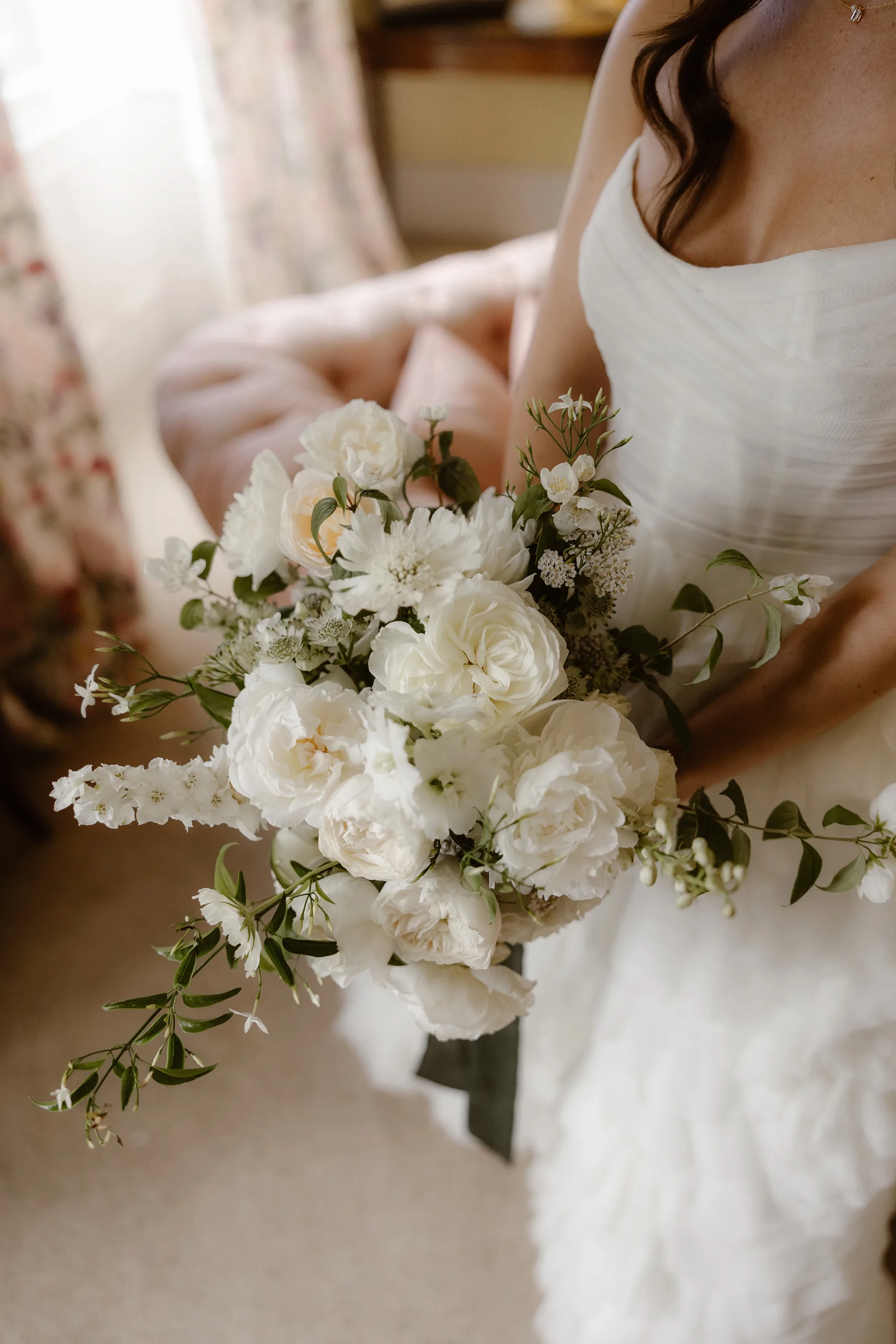 Capesthorne Hall Summer Wedding Jessica Sharpe Wedding Planner Jono Symonds Love My Dress.14 - Sophie & Dimitri's Beautiful, Relaxed & Elegant Wedding Weekend at Capesthorne Hall in Cheshire Close up shot of a bride carrying ga bouquet of white flowers with a little greenery.