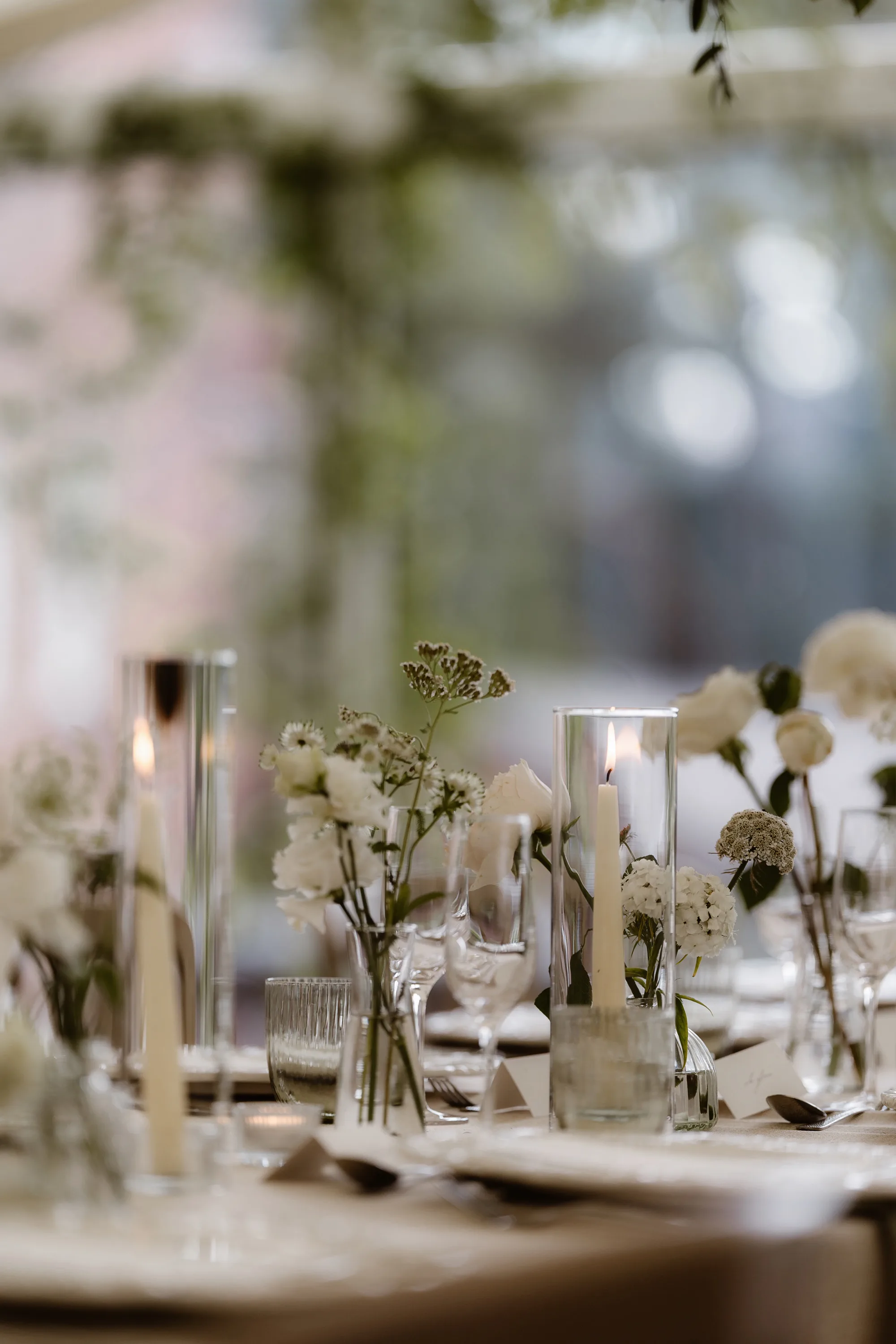 Capesthorne Hall Summer Wedding Jessica Sharpe Wedding Planner Jono Symonds Love My Dress.59 1 - Sophie & Dimitri's Beautiful, Relaxed & Elegant Wedding Weekend at Capesthorne Hall in Cheshire Glass bud vases carrying delicate white flowers and greenery.