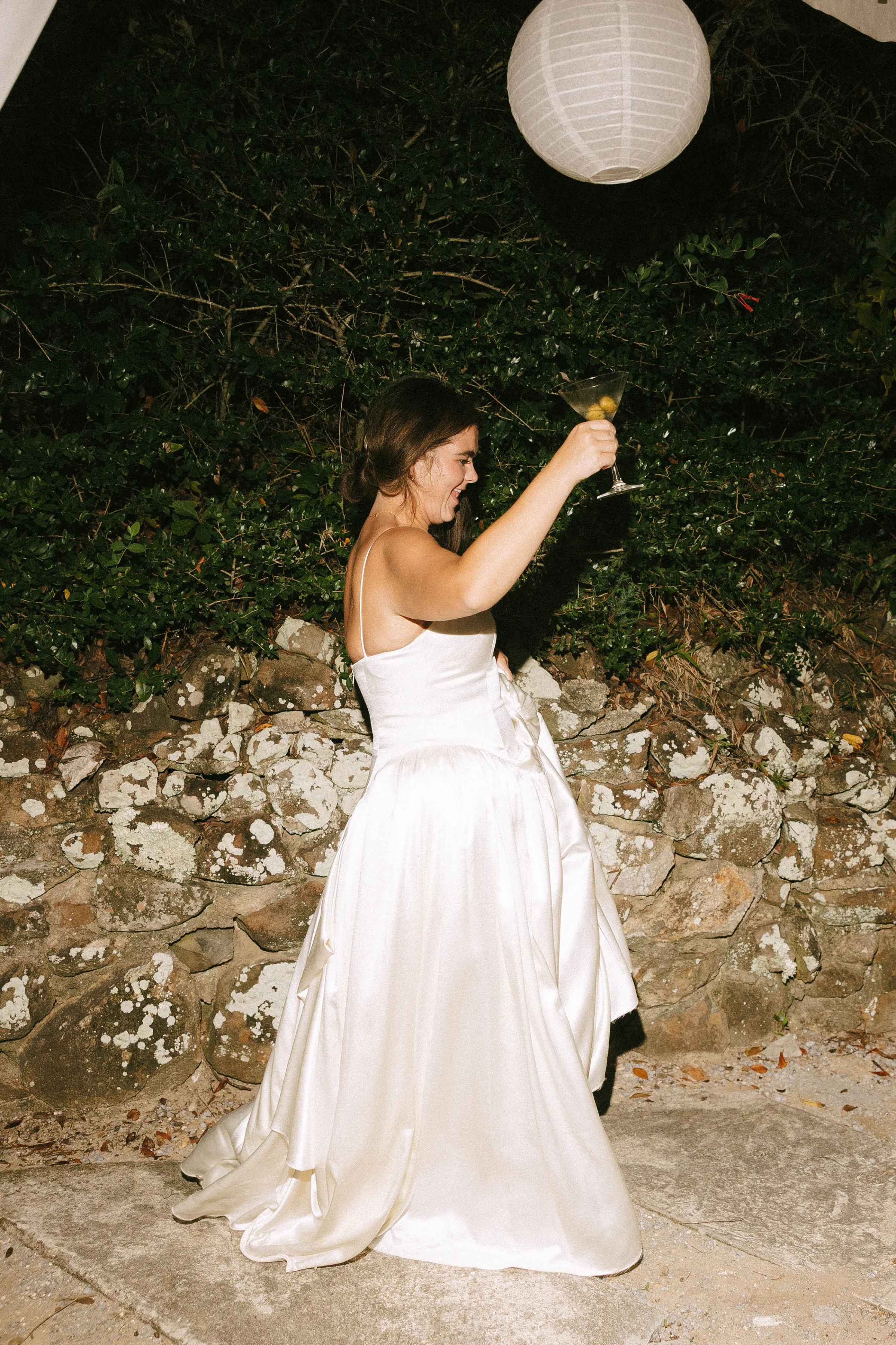 Danielle Frankel Bride Leslie DeAnne Photography.108 - Olivia in Danielle Frankel for her Intimate, Modern & Non-Traditional Wedding Bride wearing Daniel Frankel in her element at the end of the wedding day as she raises a glass of champagne.