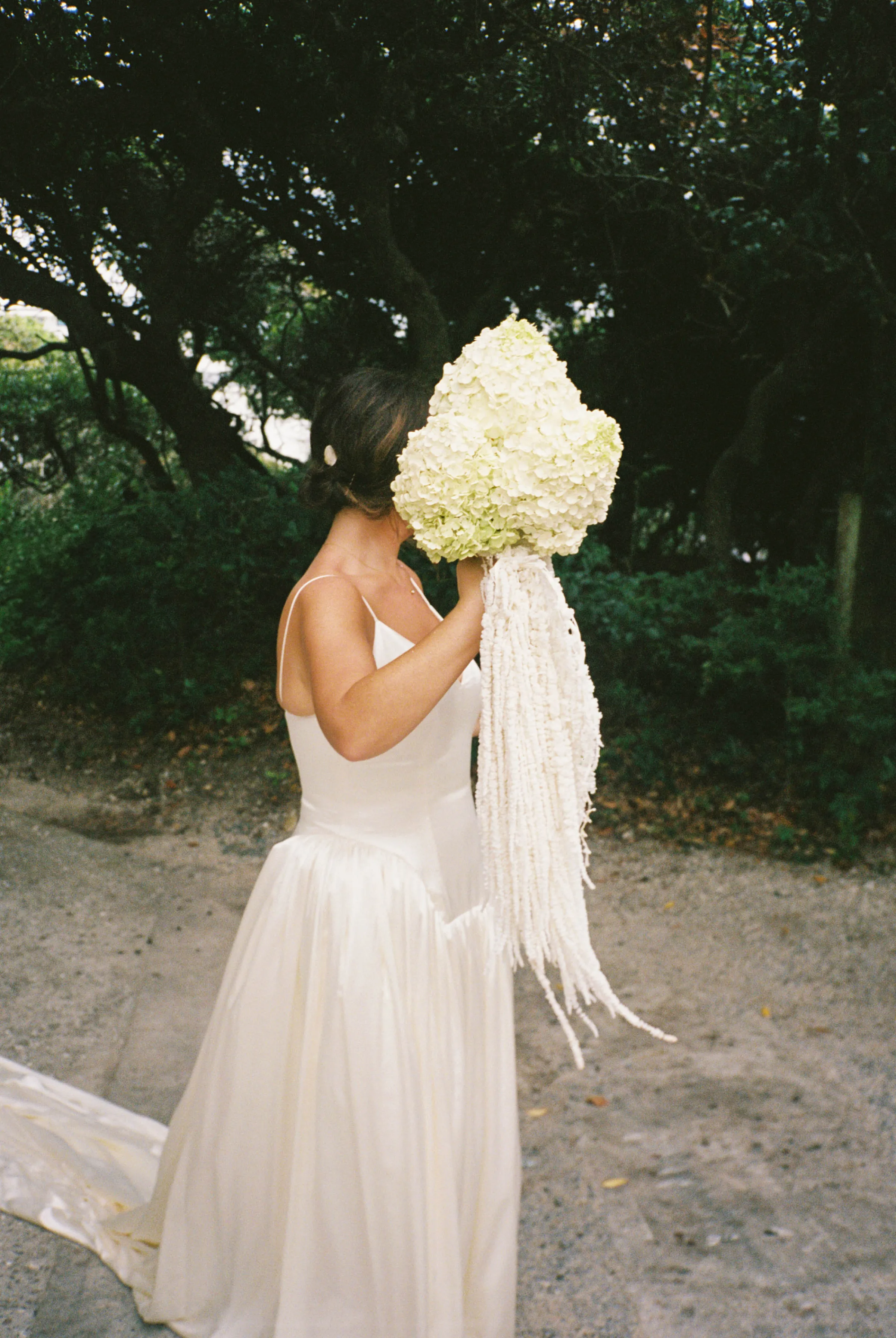 Danielle Frankel Bride Leslie DeAnne Photography.20 - Olivia in Danielle Frankel for her Intimate, Modern & Non-Traditional Wedding Bride wearing the Nina gown by Danielle Frankel. She carries a large bouquet of white hydrangea.