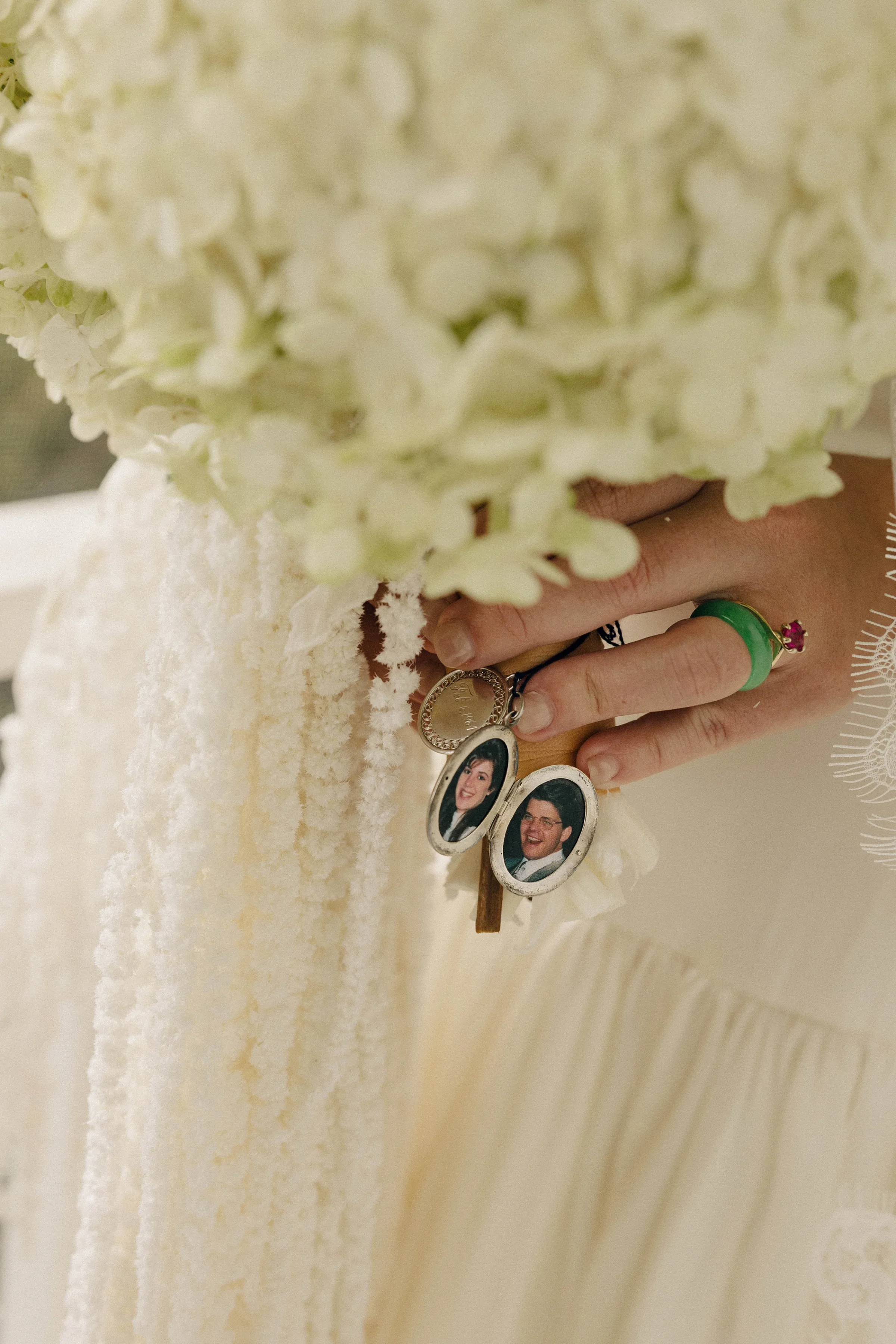 Danielle Frankel Bride Leslie DeAnne Photography.23 - Olivia in Danielle Frankel for her Intimate, Modern & Non-Traditional Wedding Close up shot of a hydrangea wedding bouquet with a locket picturing the bride's father