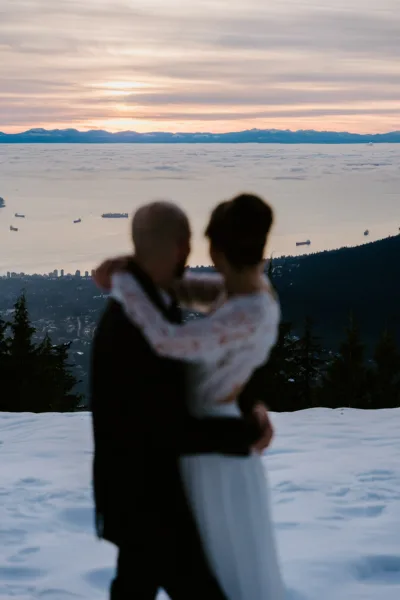 Bride and groom looking at the view of Vancouver from Grouse Mountain