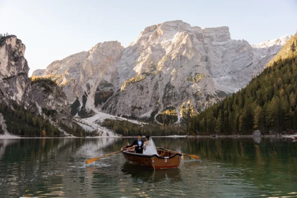 Bride and groom on a boat in front of Lago di Braies