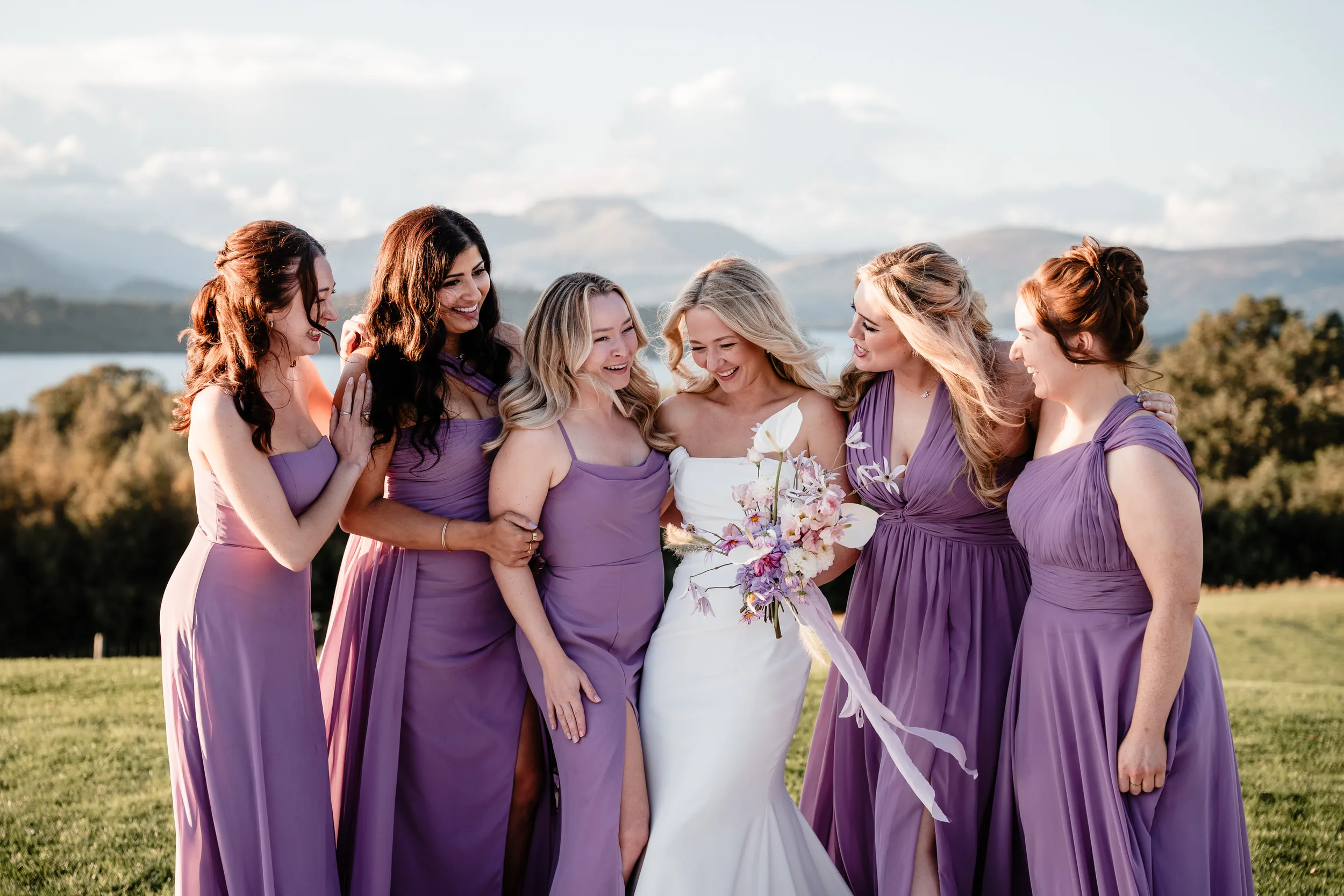 Bride with her bridesmaids dressed in lilac. Wedding at Boturich Castle wedding in Glasgow Scotland