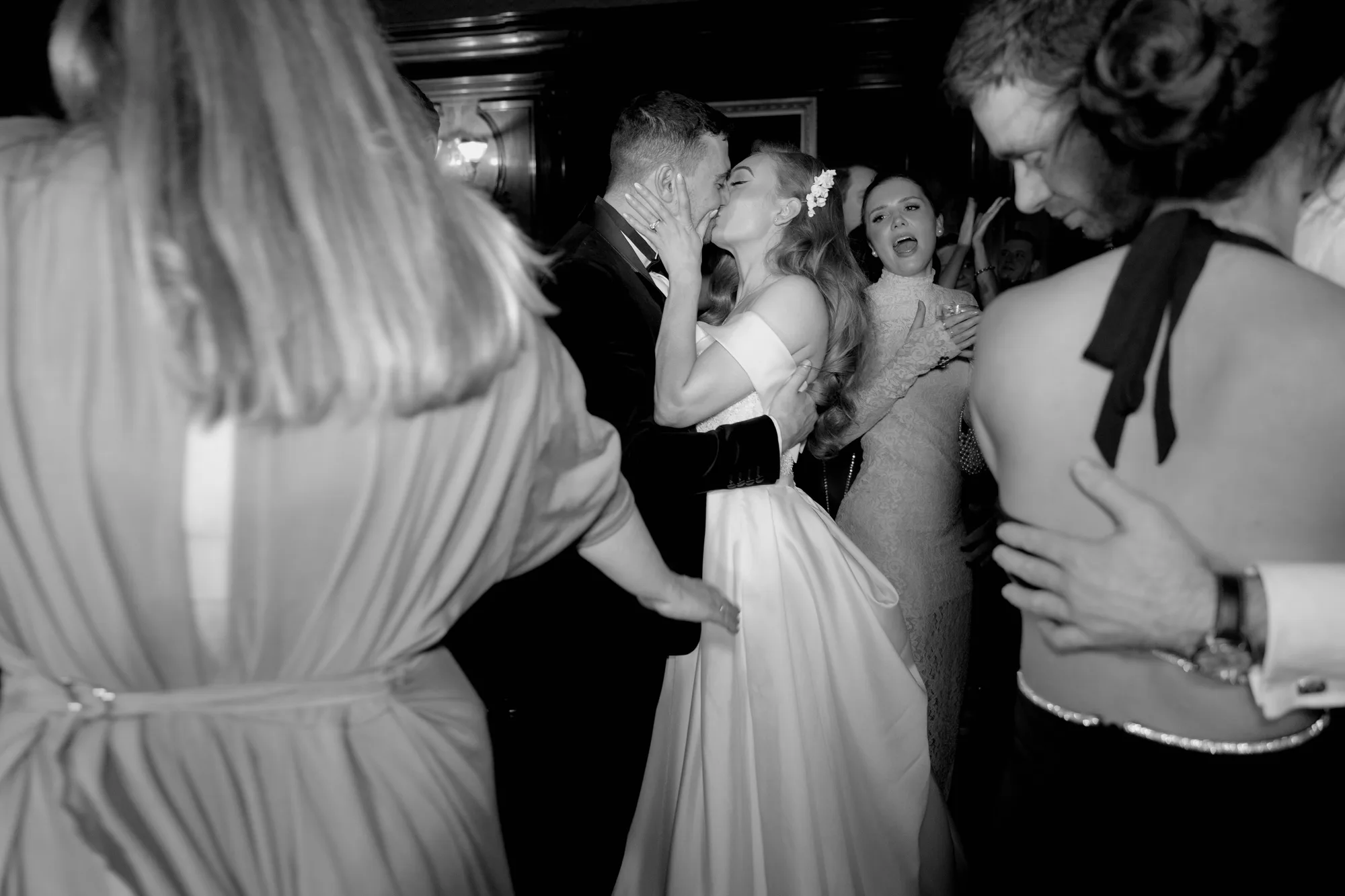 Bride and groom sharing a kiss on the dance floor during the evening wedding reception at Ashridge House in Hertfordshire.