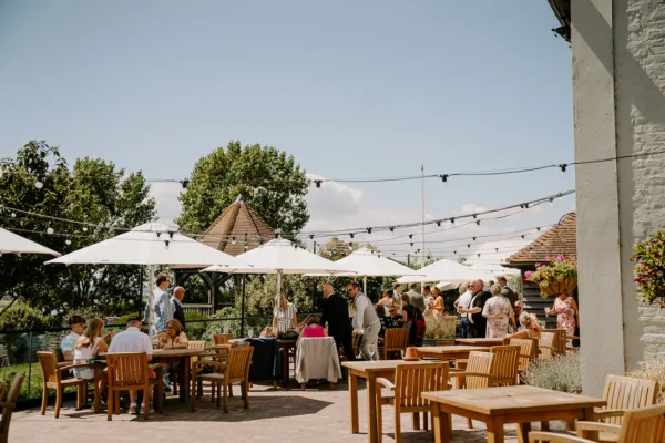A sunny waterside drinks reception at a wedding venue in Kent
