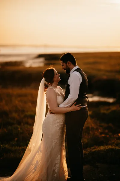 Newlyweds share a tender moment at a waterside Kent wedding venue