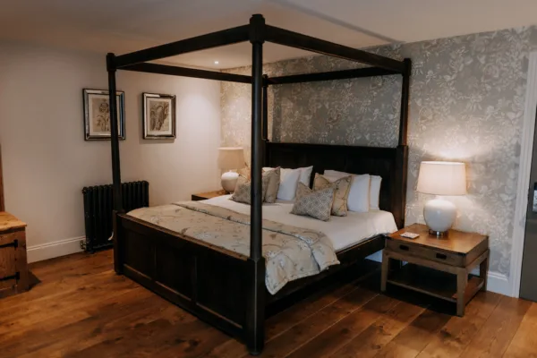 Wedding accommodation with a four poster bed at a barn wedding venue in Kent