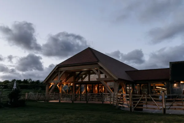 Exterior of The Harty Estate's wedding barn at twilight