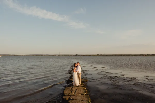 Bride and groom share at a tender moment at their coastal wedding venue in Kent